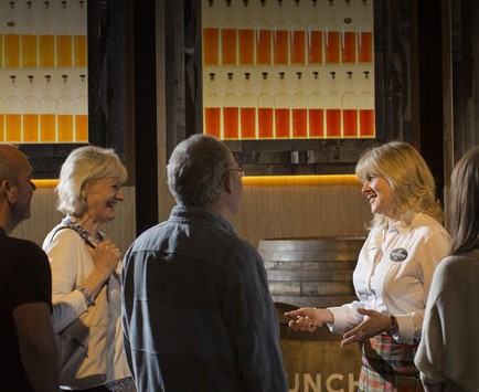 A guide explaining the whisky making process to visitors at Glengoyne Distillery